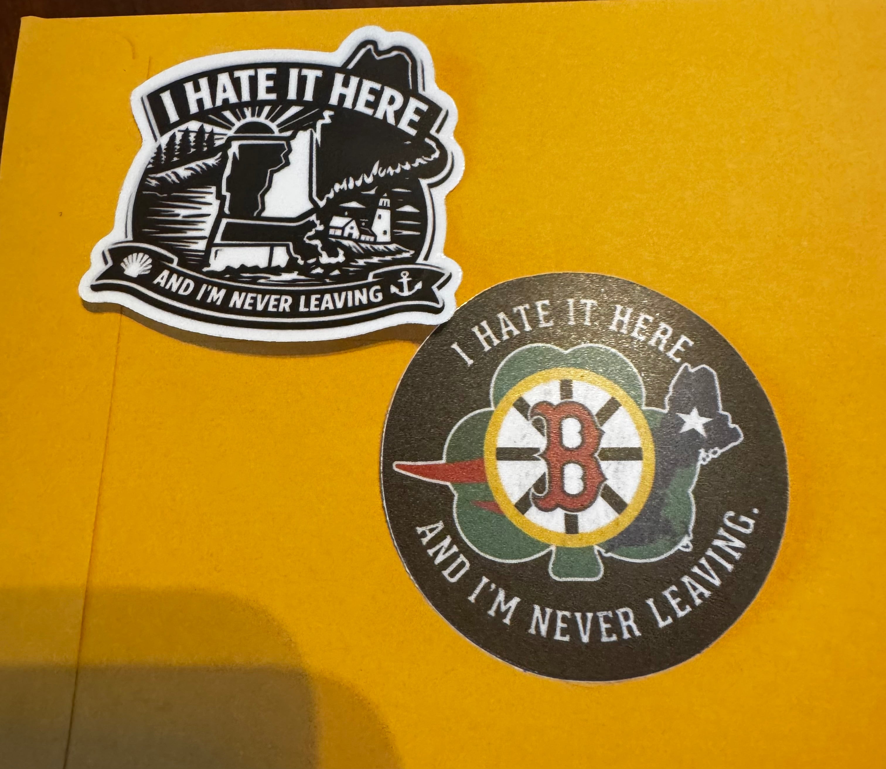 Hate it here “sports” theme sticker. And traditional I hate it here and never leaving themed sticker in black and white.